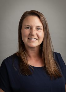 Amber Arthurs is a middle-aged white women, with brown hair, hazel eyes.
