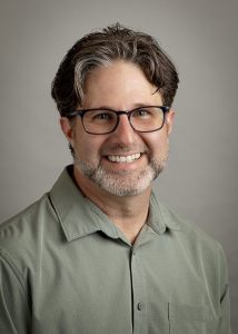 Patrick Yoerger is a middle-aged man with dark hair and glasses.